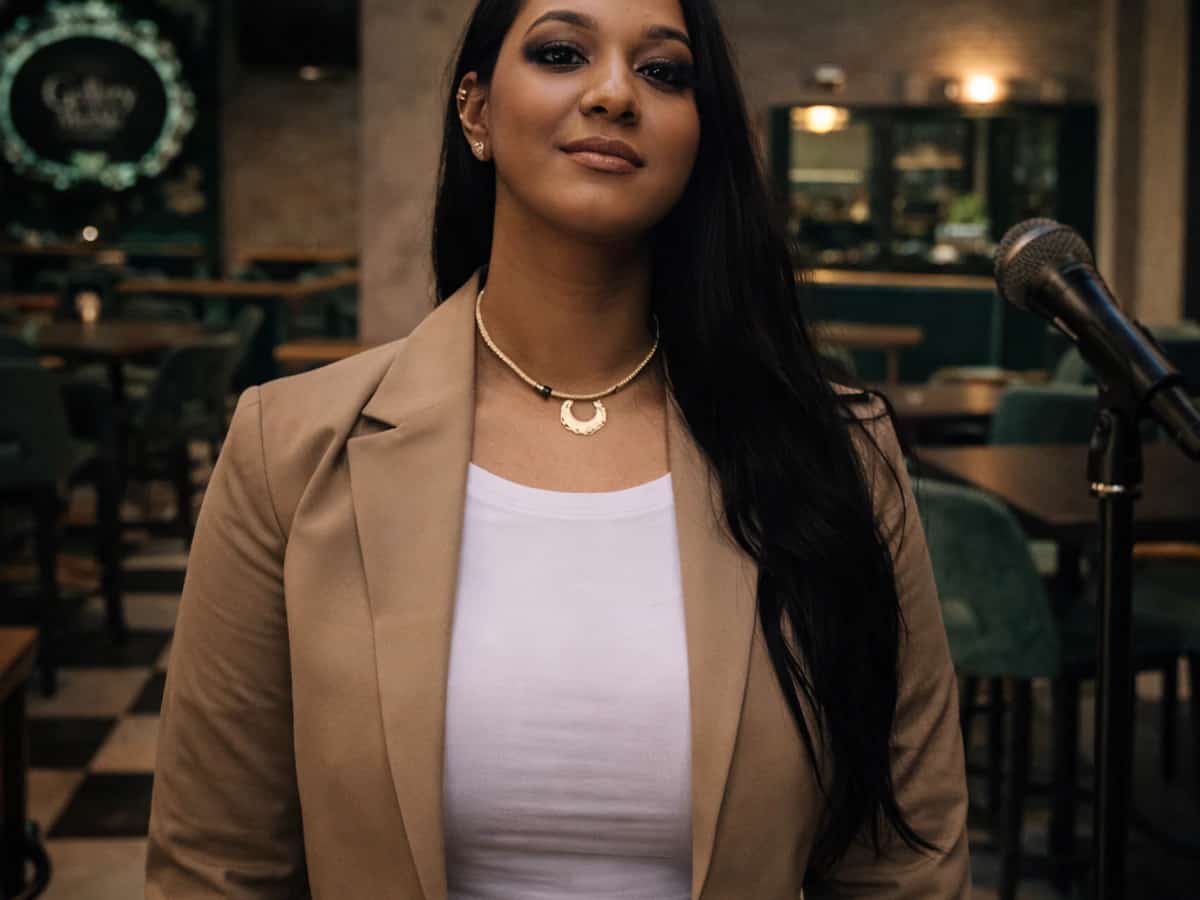 Anhais Martín posando junto a un micrófono en Gallery Marbella durante un tardeo premium con música en directo en Marbella, flamenco en vivo y ambiente lounge ideal para el Día de Andalucía y plan de tarde.